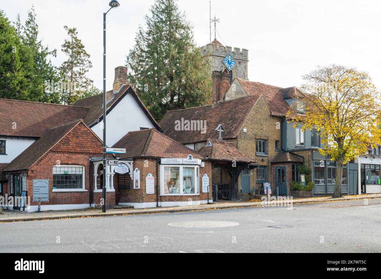 View of St Martins Church tower, the Priory Cafe and shops on High Street, Ruislip, Middlesex, England, UK Stock Photo