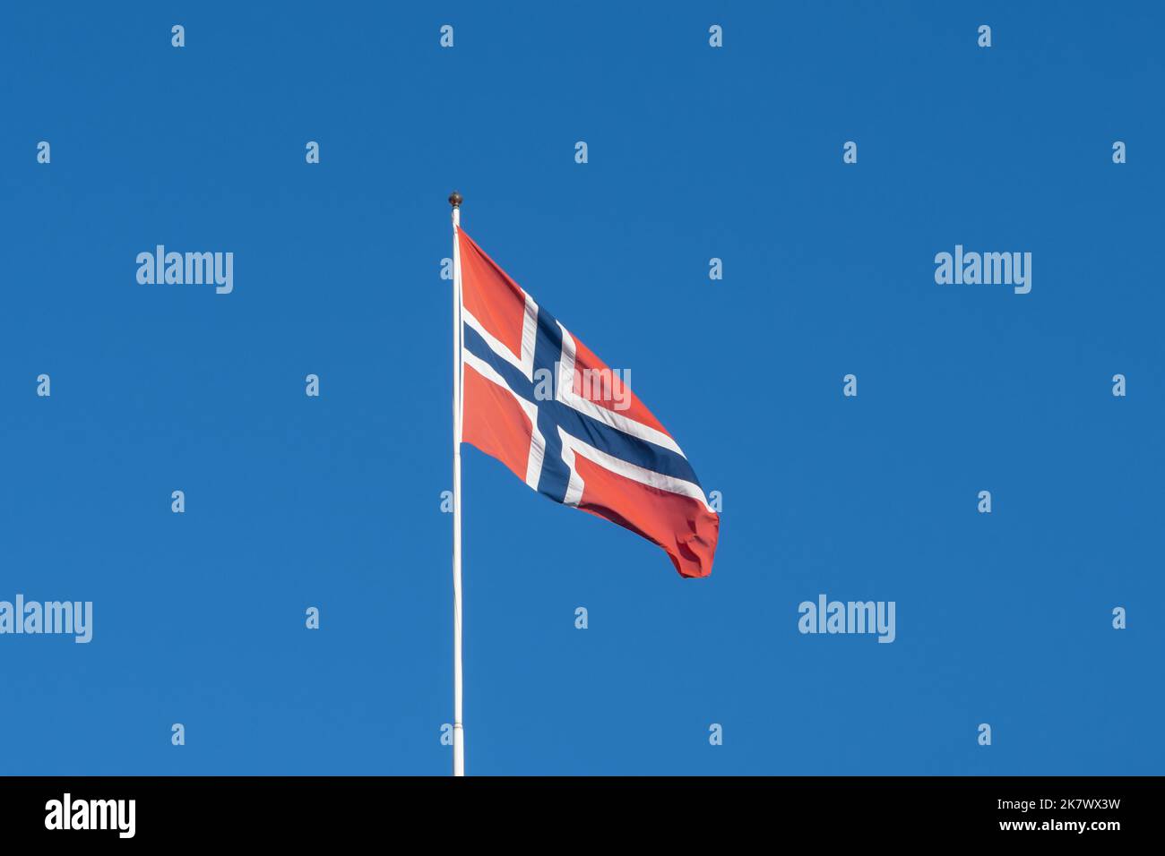 A waving Flag of Norway with blue sky in background Stock Photo - Alamy