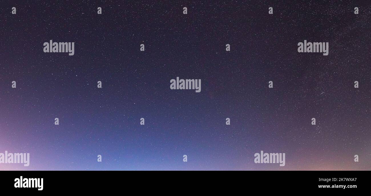 Night starry sky with glowing stars. Night starry sky background. Panorama, panoramic view Stock Photo