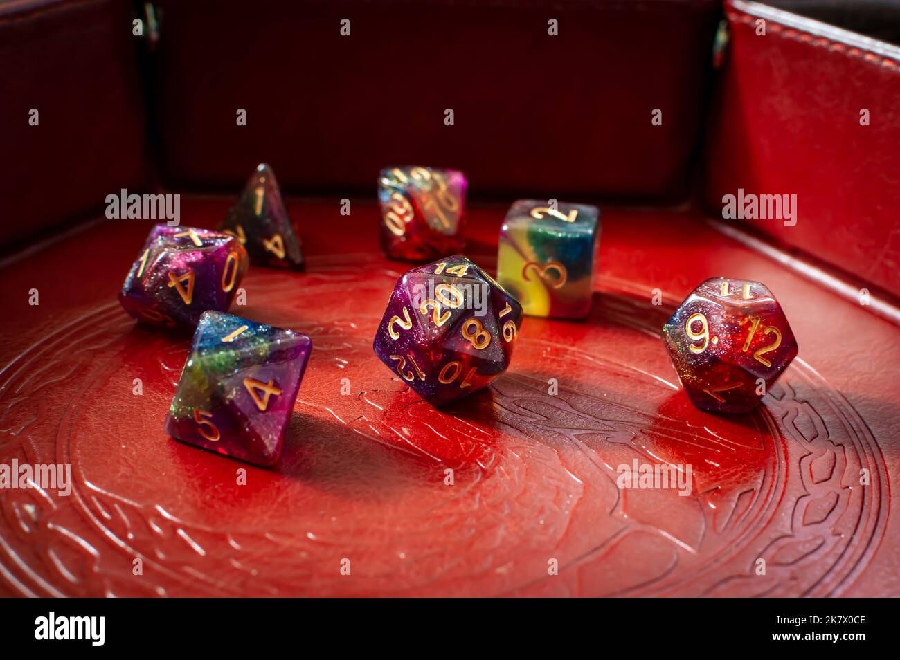Closeup image of a set of colorful roleplaying gaming dice in a brown