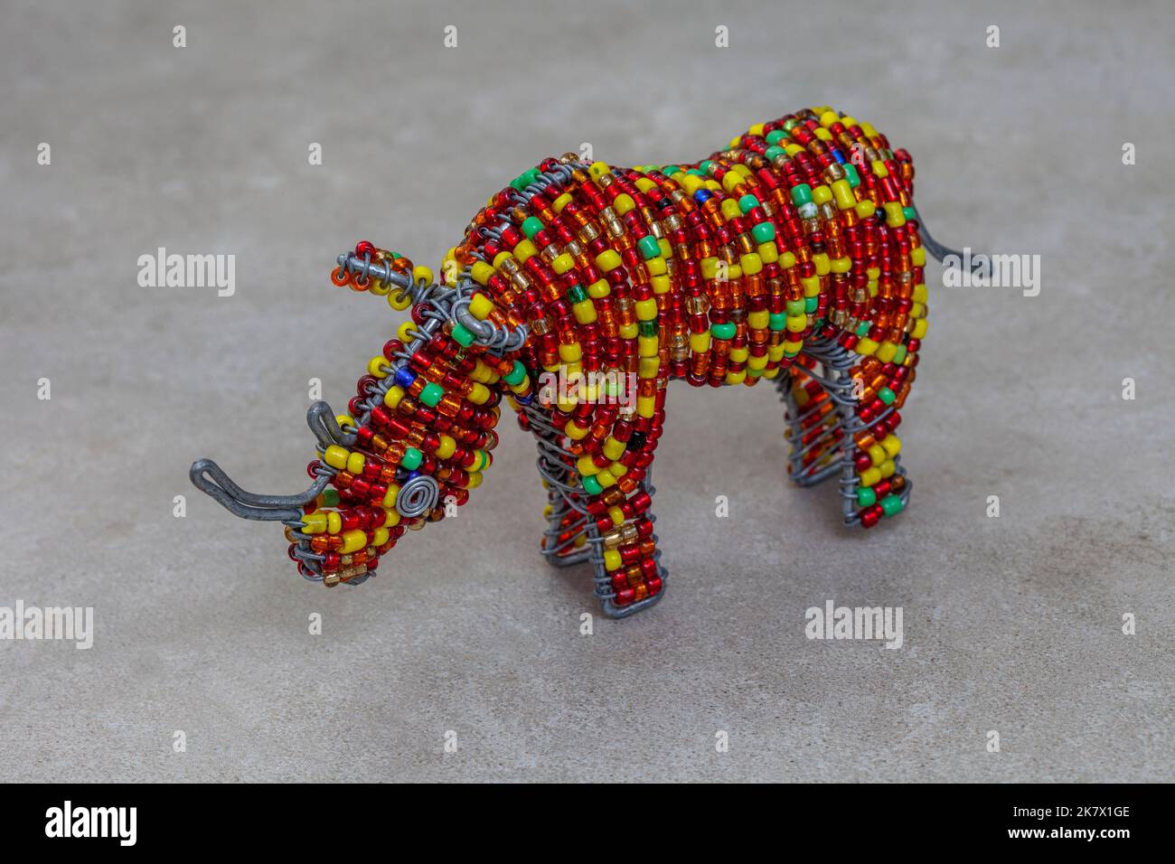 colorful South African beaded craft of Rhinoceros on mottled grey with copy space Stock Photo