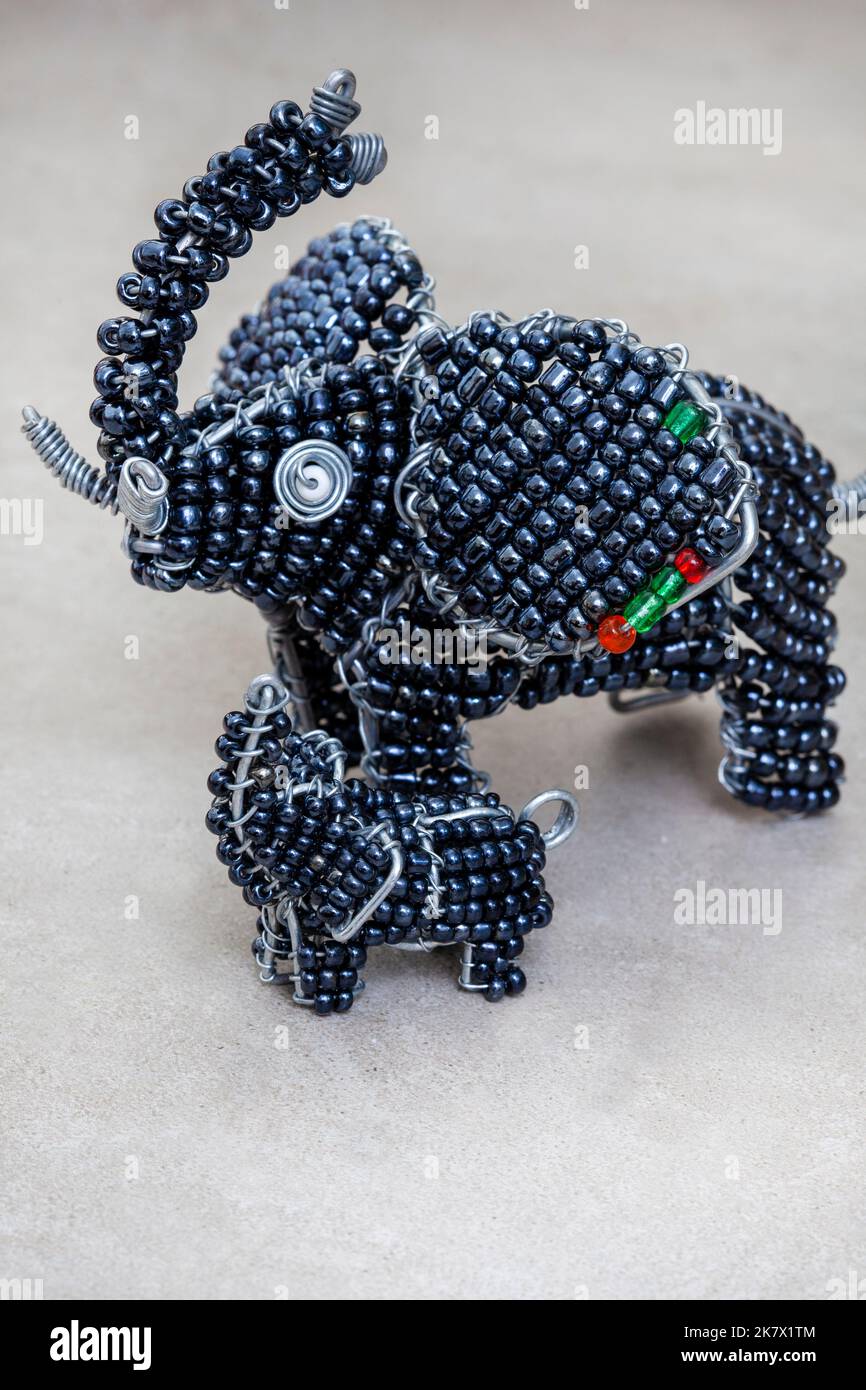 Beaded figurine of African Elephant on mottled grey with copy space Stock Photo