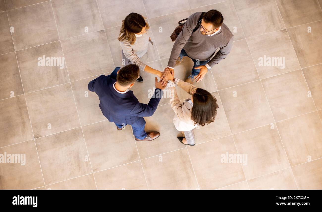 Aerial view at business people team stack hands as unity gesture in the ...