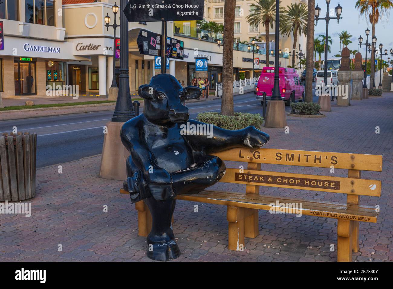 Close up view of cute black hippo statue on advertising bench of LG.Smith's steak  chop house. Oranjestad, Aruba. Stock Photo