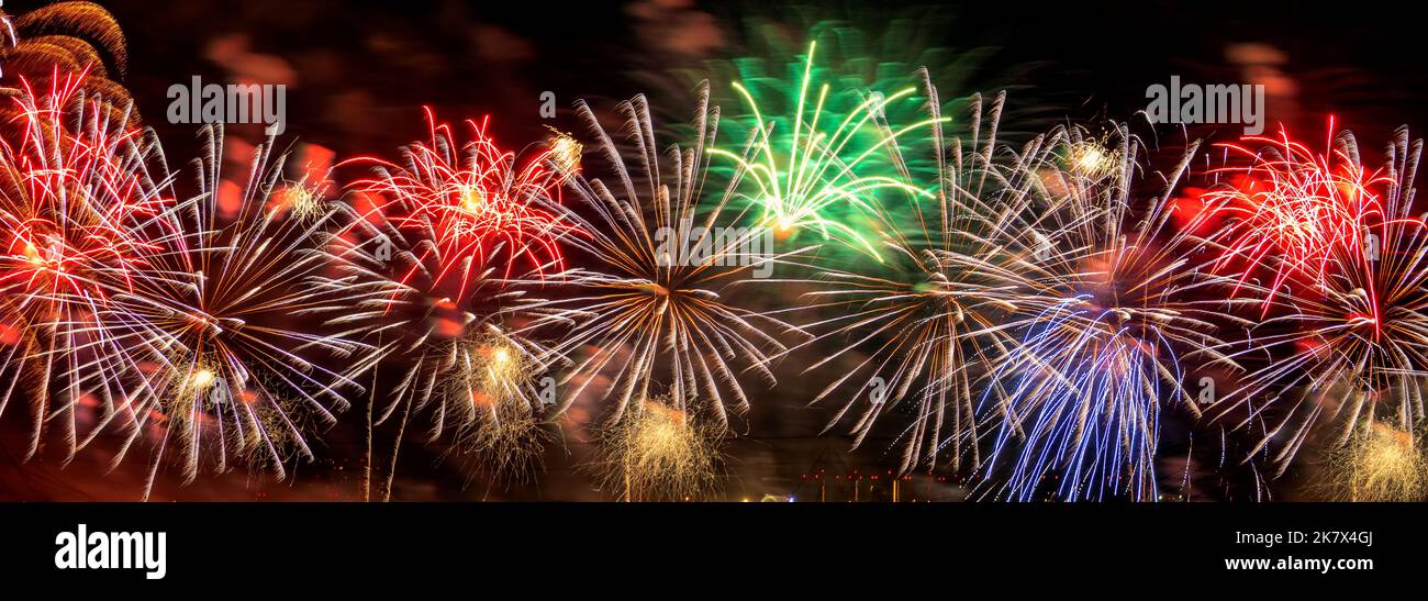 Panorama of New Year celebration colorful fireworks. Stock Photo