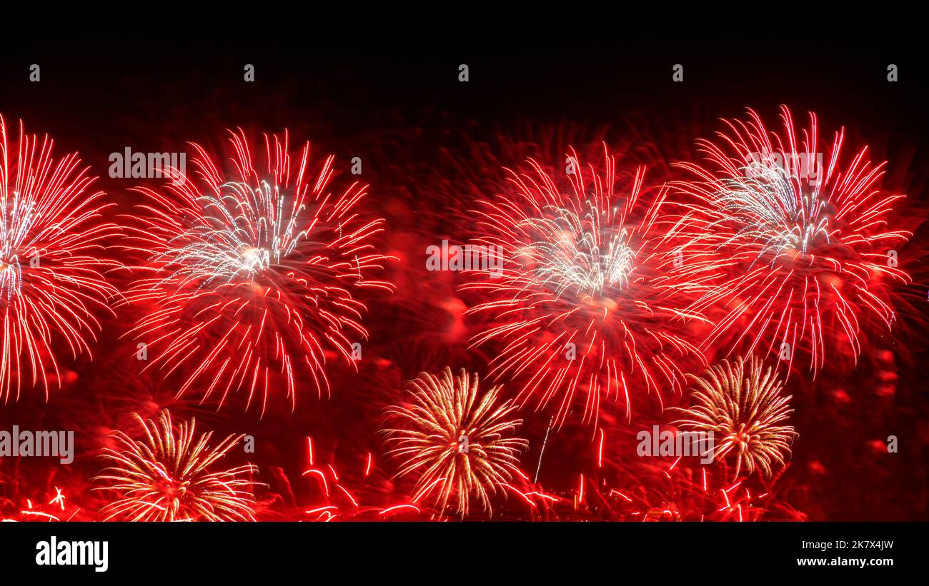 Holiday red firework with copy space for New Year celebration. Stock Photo