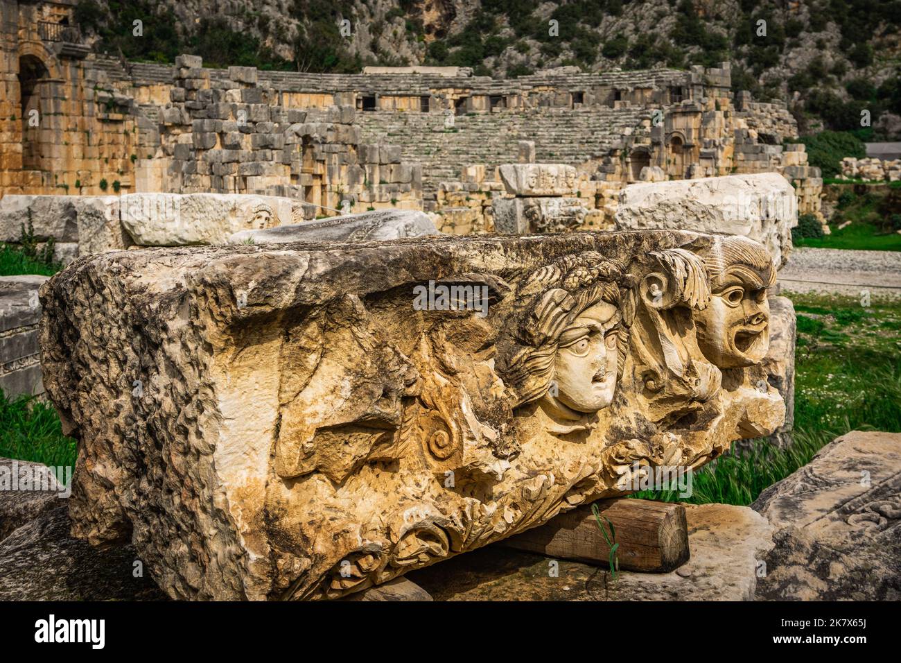 Stone Theater masks in Myra Ancient City. Ancient Myra Theater in background. Demre, Antalya, Turkey Stock Photo
