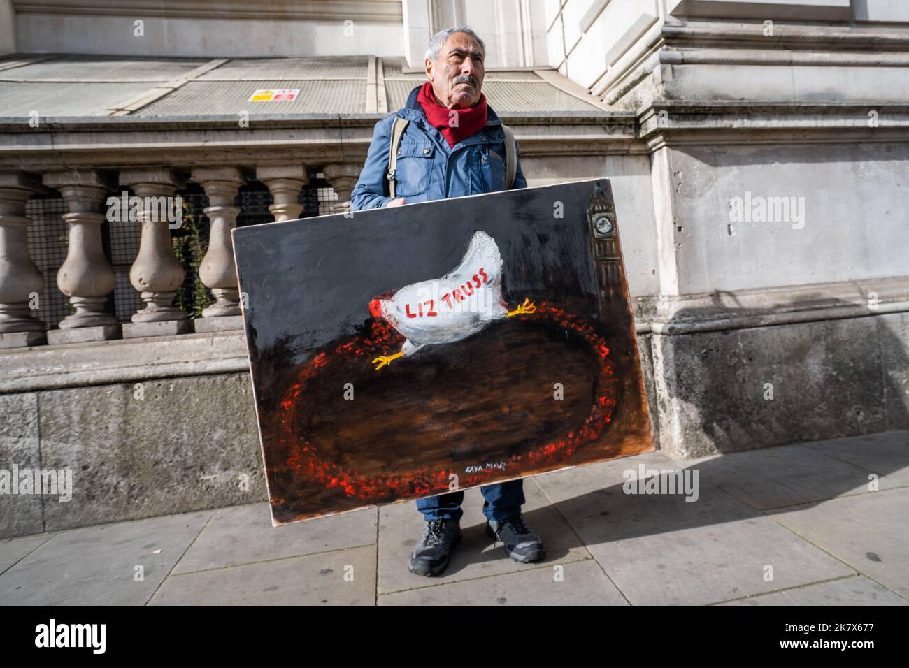 London UK. 19 October 2022 . Artist Kaya Mar holds his painting  outside Downing Street depicting Liz Truss as a headless chicken.  Prime Minister Liz Truss faces growing  pressure to resign from her own  conservative backbenchers following the dramatic u-turn to her economic  and by the Labour opposition calling for a general election  following the dramatic  U turn on the mini budget. and sacking of chancellor Kwasi Karteng. Credit: amer ghazzal/Alamy Live News Stock Photo