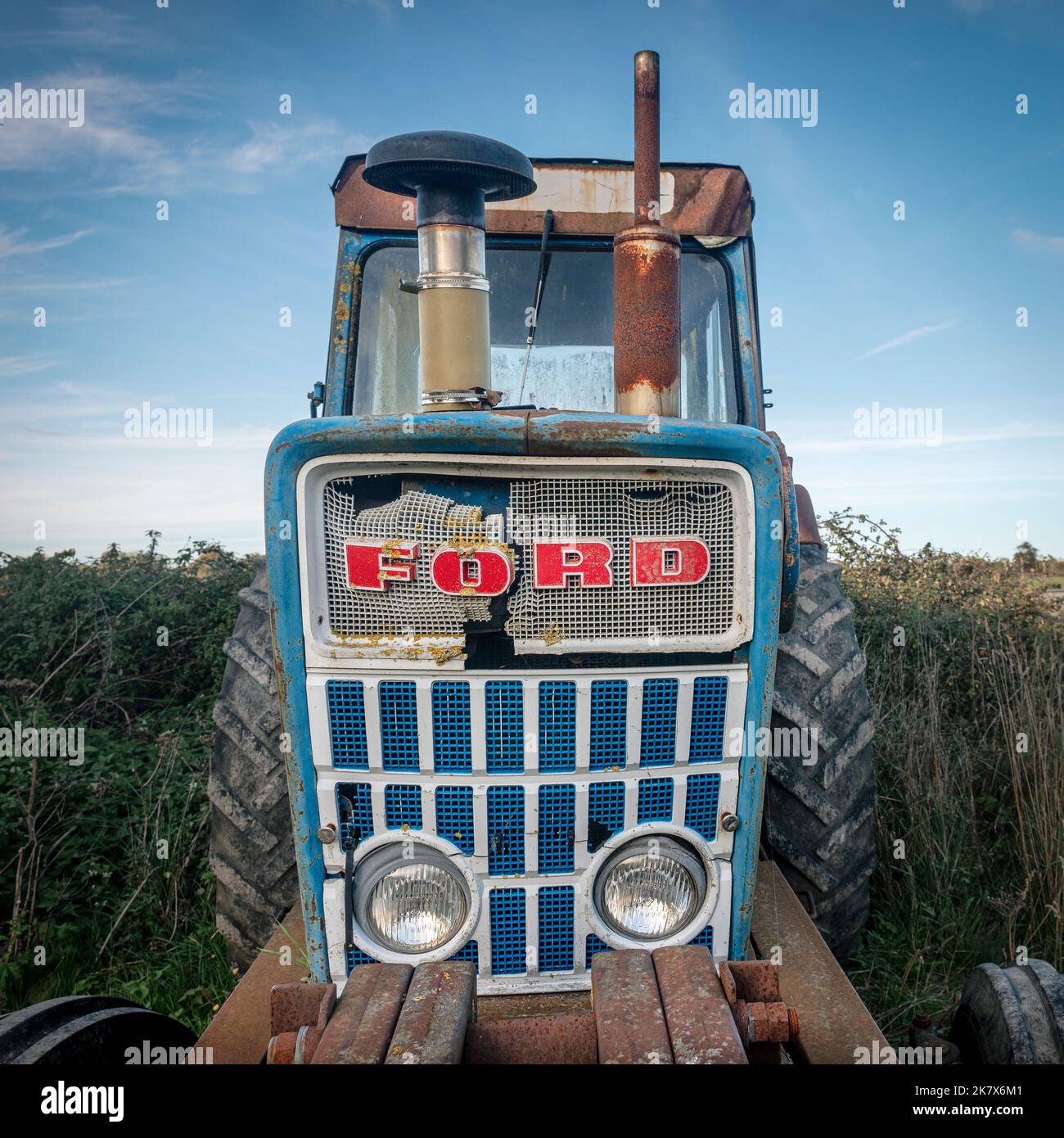 Old Ford tractor in a field, front view. Stock Photo