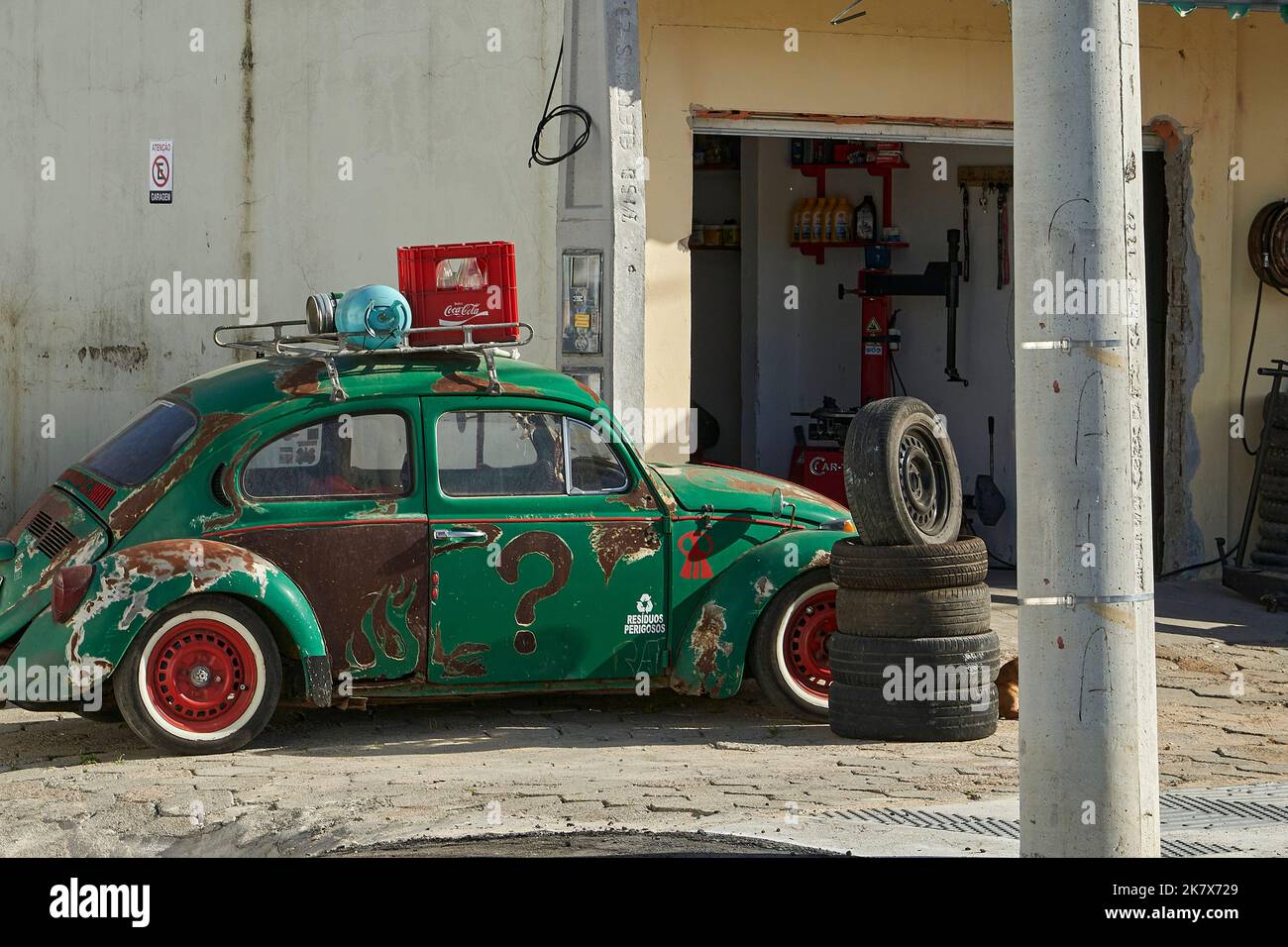 old classic historical Volkswagen vintage beetle whit whitewall tires and rust on the body Stock Photo