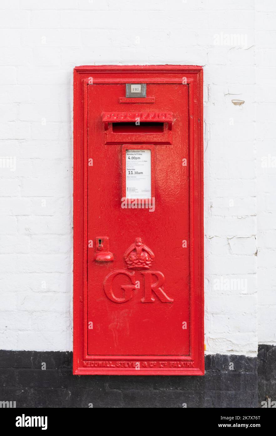 Red Post Box in wall with the symbol GR for King George V post box Royal mail post box uk in the Suffolk village of Orford Suffolk England UK Europe Stock Photo