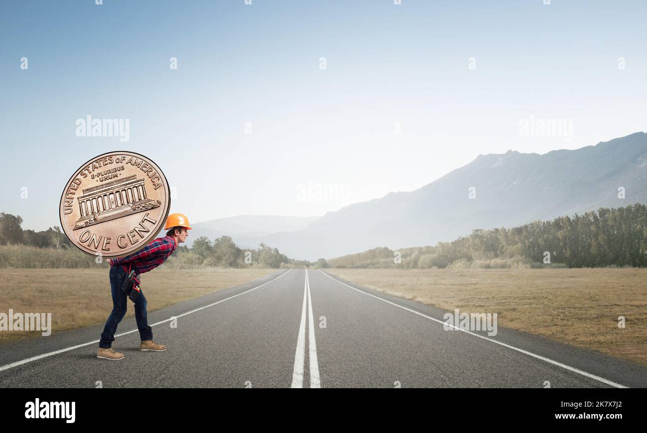 Builder man carry coin Stock Photo Alamy