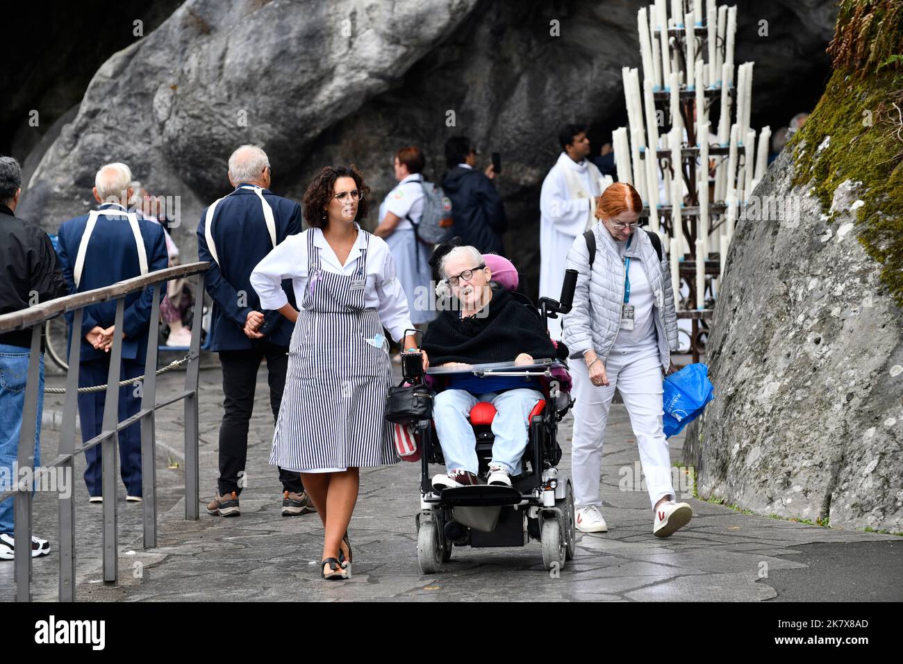 Lourdes, HautesPyr??n??es, France. Carer with pilgrim in wheelchair