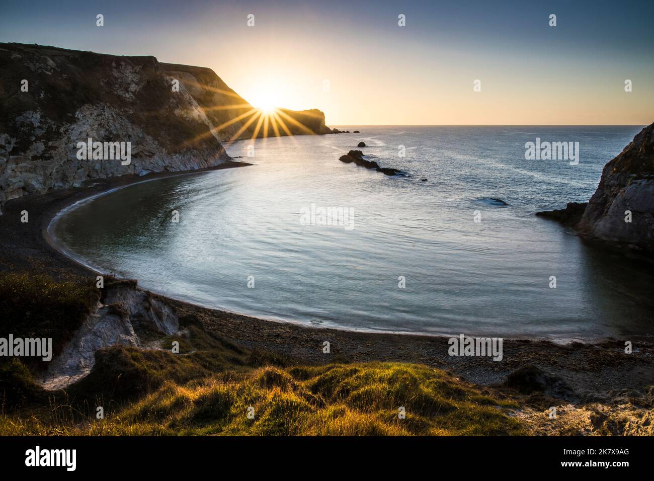 Sunrise over Man O'War Beach and St.Oswald's Bay looking east towards Dungy Head in Dorset. Stock Photo