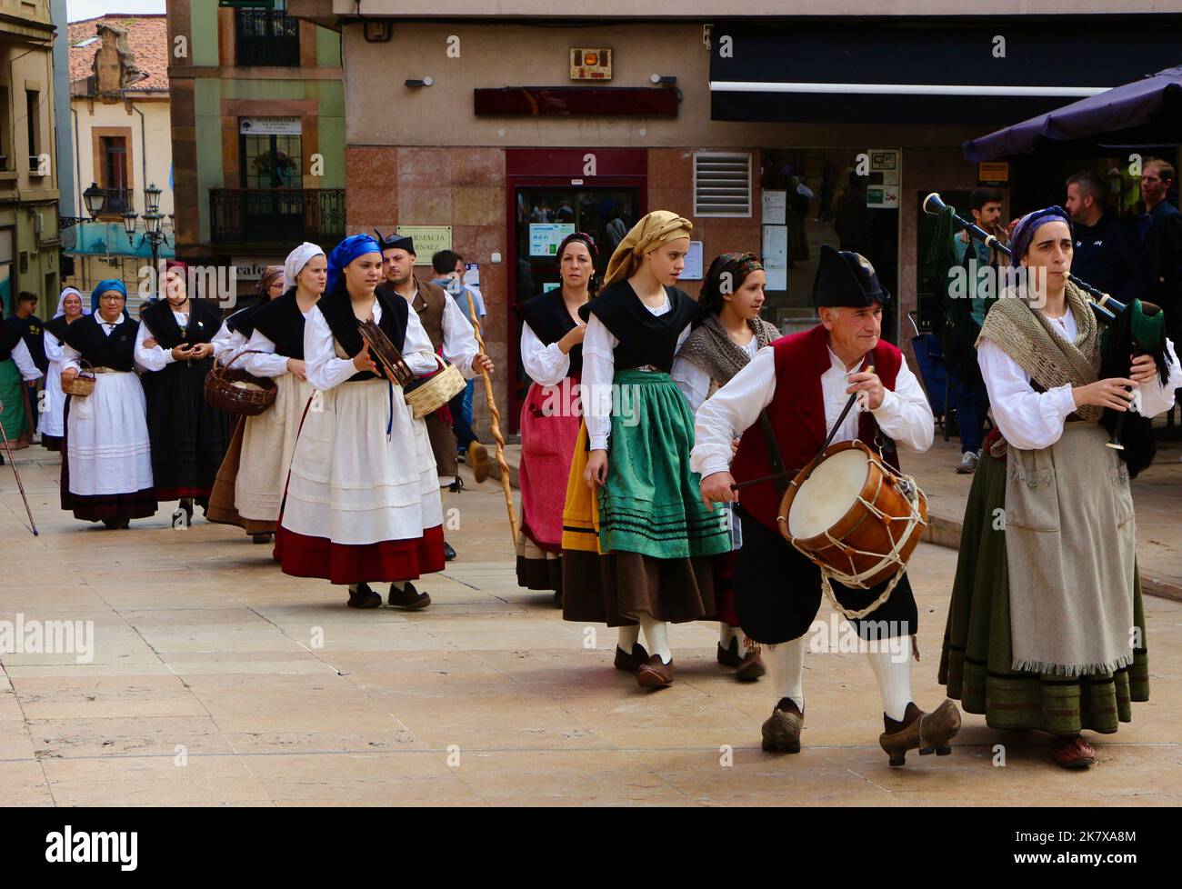 A folk dance group in traditional costumes walking in procession to