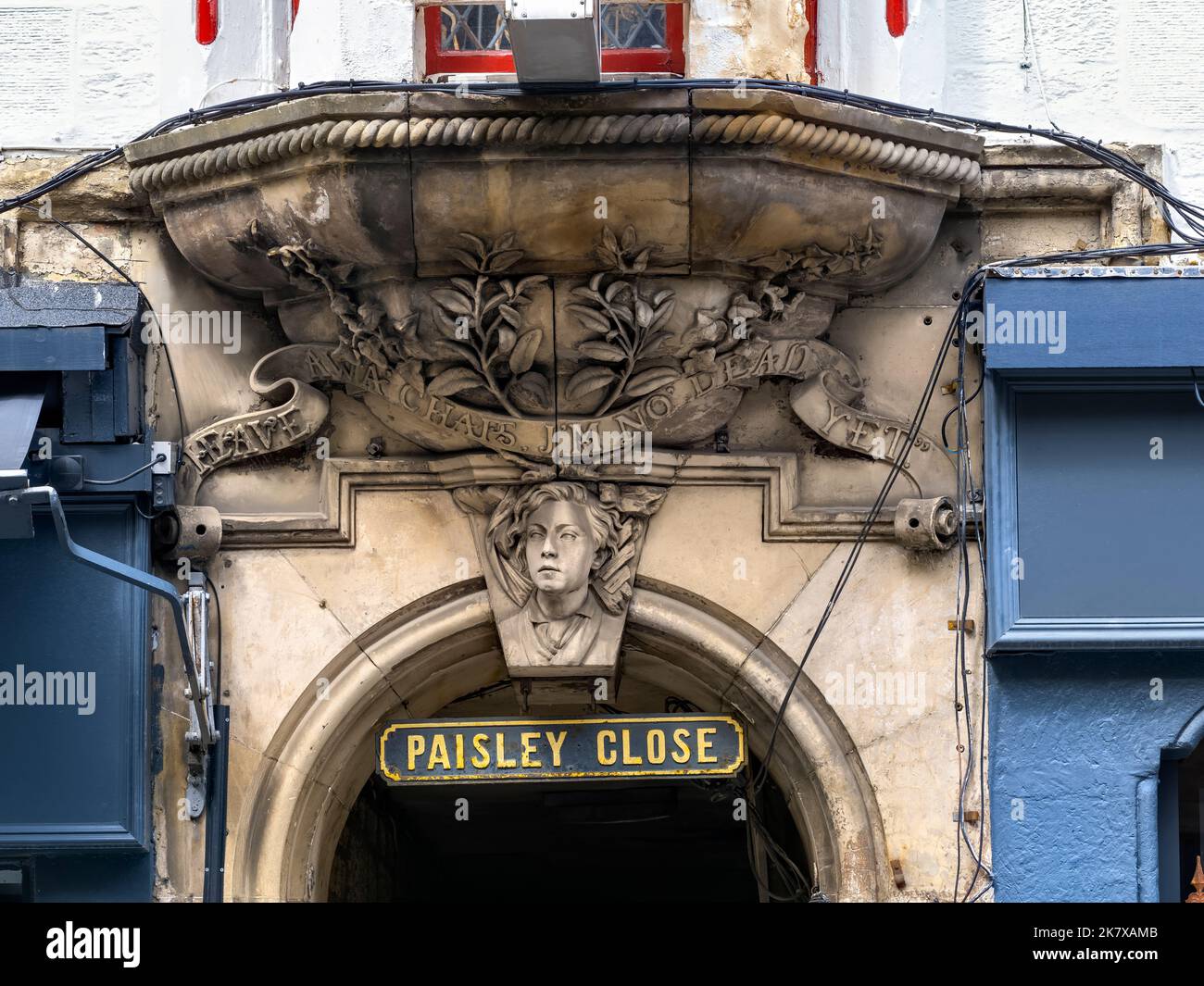 Heave awa' chaps, I'm no' dead yet! - The entrance to Paisley Close and the bust of a boy saved from the rubble when the building above collapsed. Stock Photo