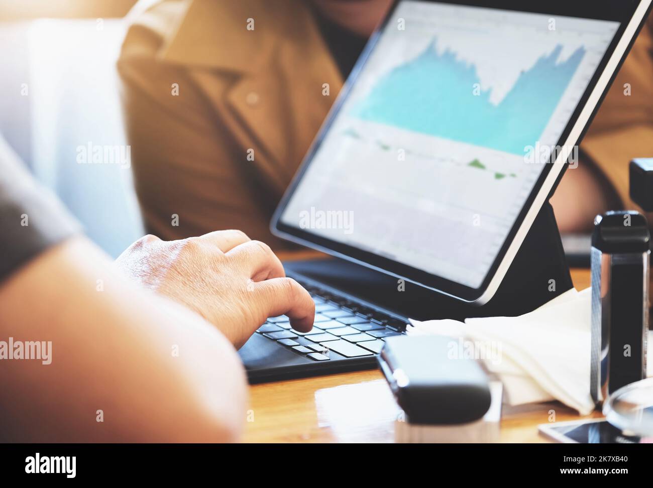 focus hands of a speculator who is using a tablet to trade stocks to