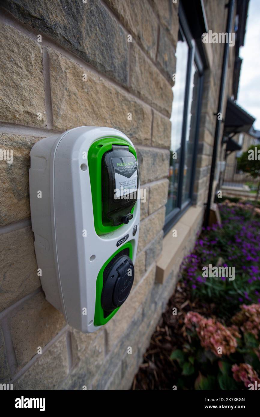 Electric car charging point on a new house being built by Taylor Wimpey