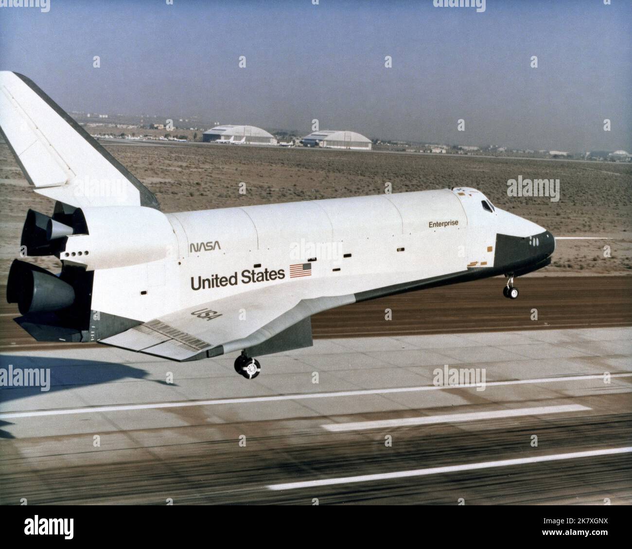 Piloted by astronauts Fred Haise and Gordon Fullerton, the prototype space shuttle Enterprise settles toward the main runway at Edwards Air Force Base on its final Approach and Landing Test flight on Oct. 26, 1977. Stock Photo