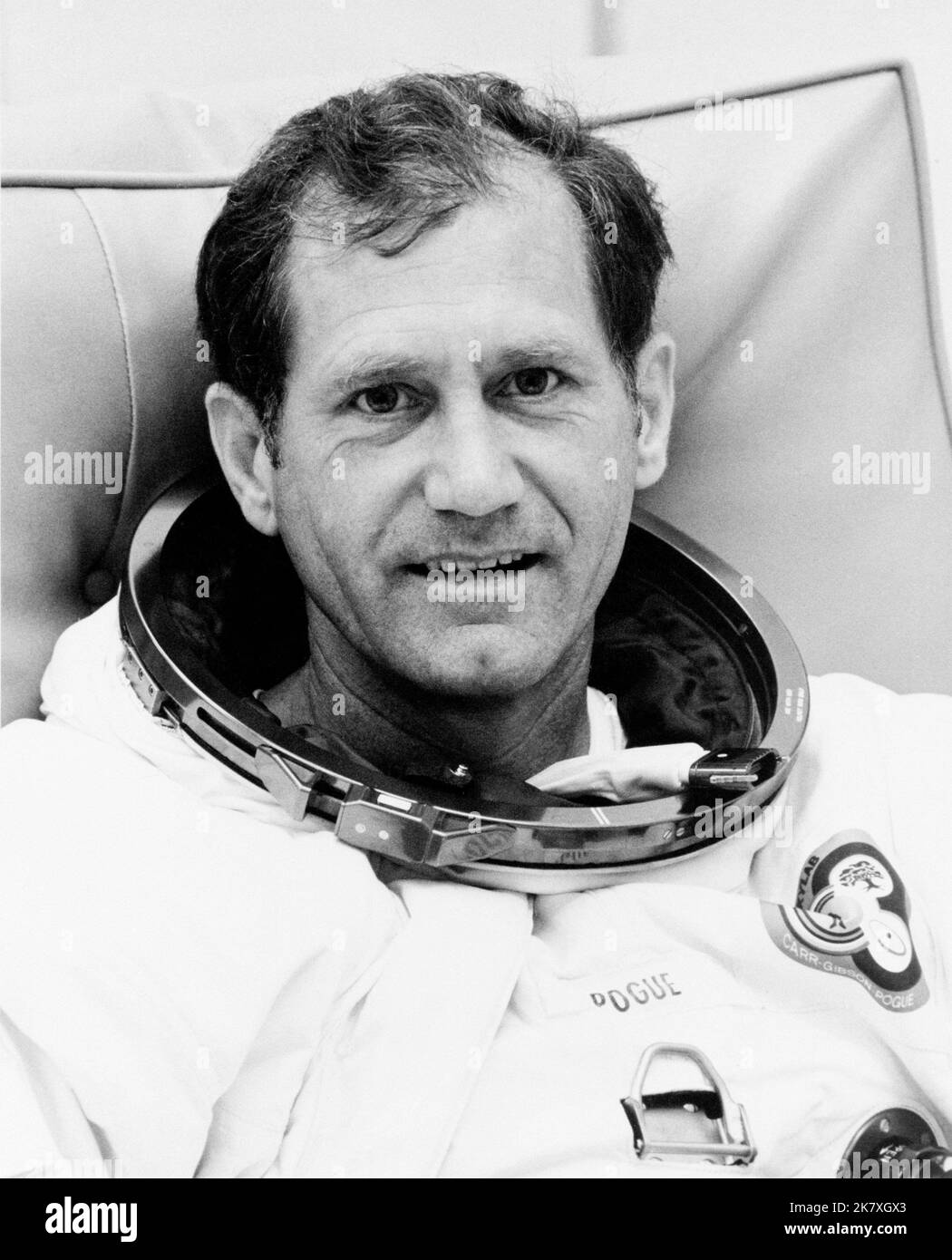 Astronaut William R. Pogue, pilot of the Skylab 4 mission, relaxes during spacesuit pressure and fit checks at the Kennedy Space Center Stock Photo