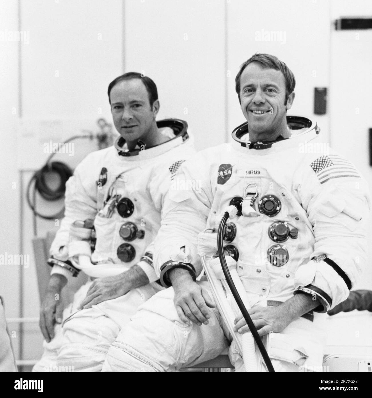Astronauts Alan B. Shepard Jr. (right), commander, and Edgar D. Mitchell, lunar module pilot, are suited up for a manned altitude run in the Apollo 14 Lunar Module (LM). Stock Photo