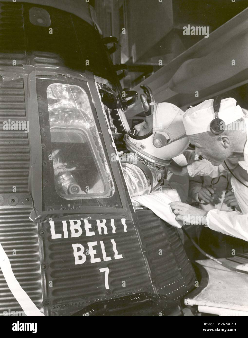 Astronaut Gus Grissom climbs into 'Liberty Bell 7' spacecraft before launch on the morning of July 21, 1961. Astronaut John Glenn, Grissom's back up, helps him into the capsule. Stock Photo
