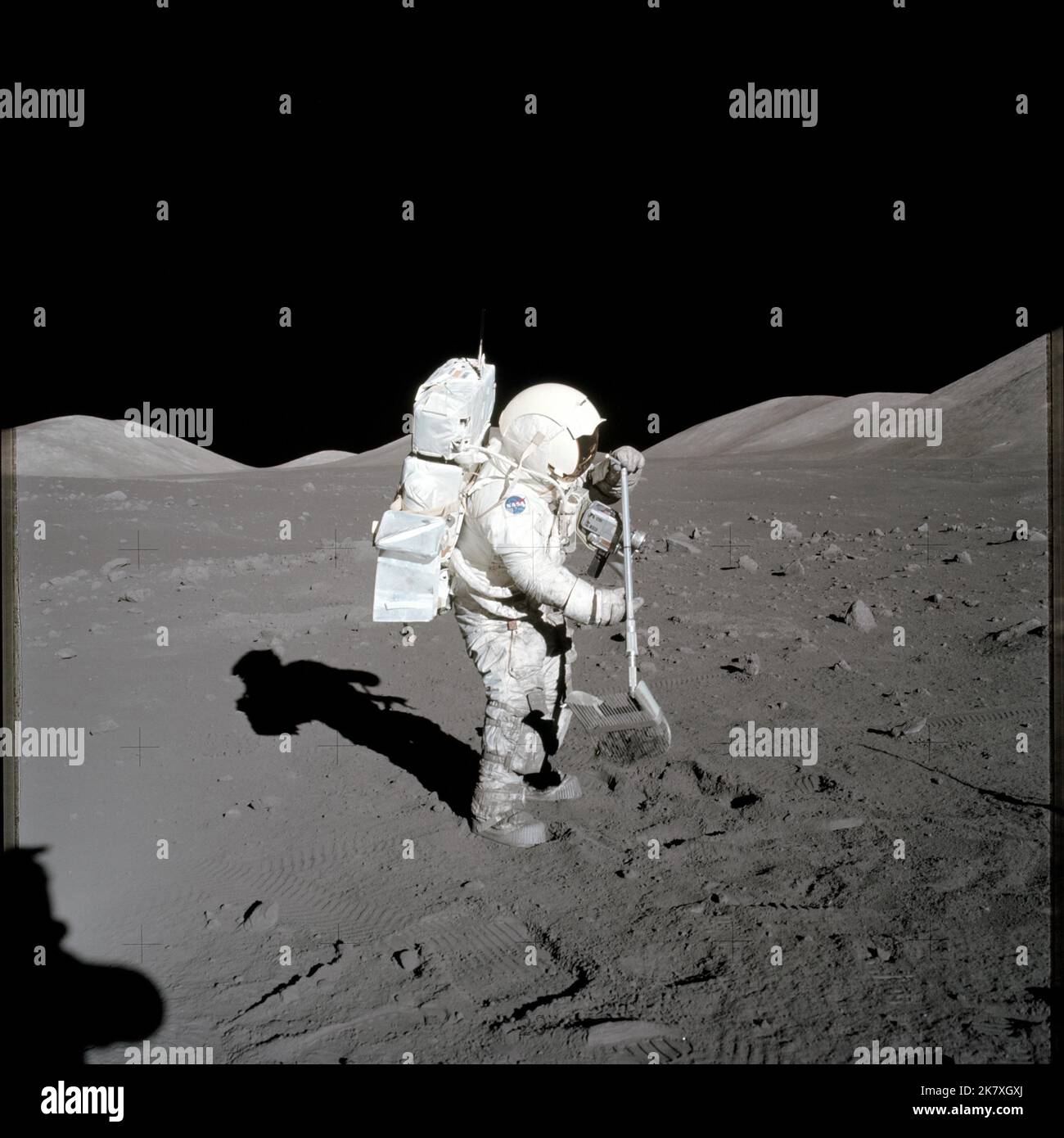 Scientist-astronaut Harrison H. Schmitt, Apollo 17 lunar module pilot, collects lunar rake samples at Station 1 during the mission's first spacewalk at the Taurus-Littrow landing site. Stock Photo