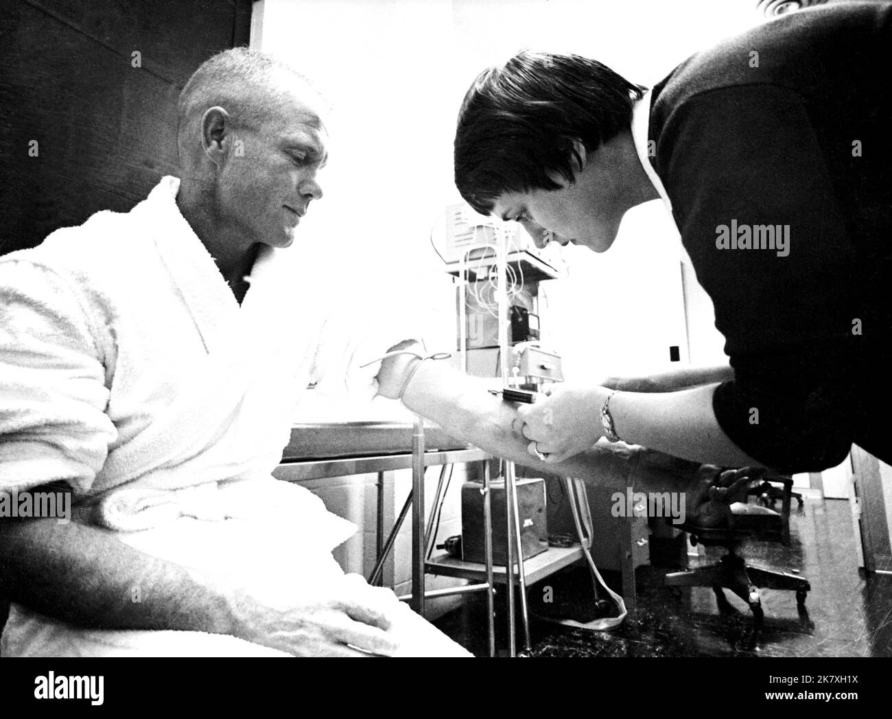 Astronaut nurse Delores B. O'Hara, R.N., in the Aeromedical Laboratory at Cape Canaveral, Florida, takes a blood sample from Mercury astronaut John H. Glenn Jr. Stock Photo