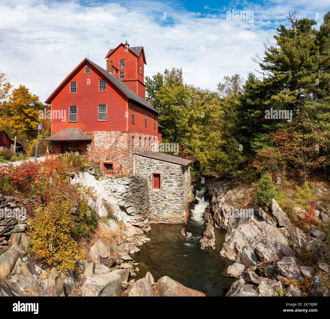Side view of the Old Red Mill by the creek in Jericho Vermont during the fall Stock Photo