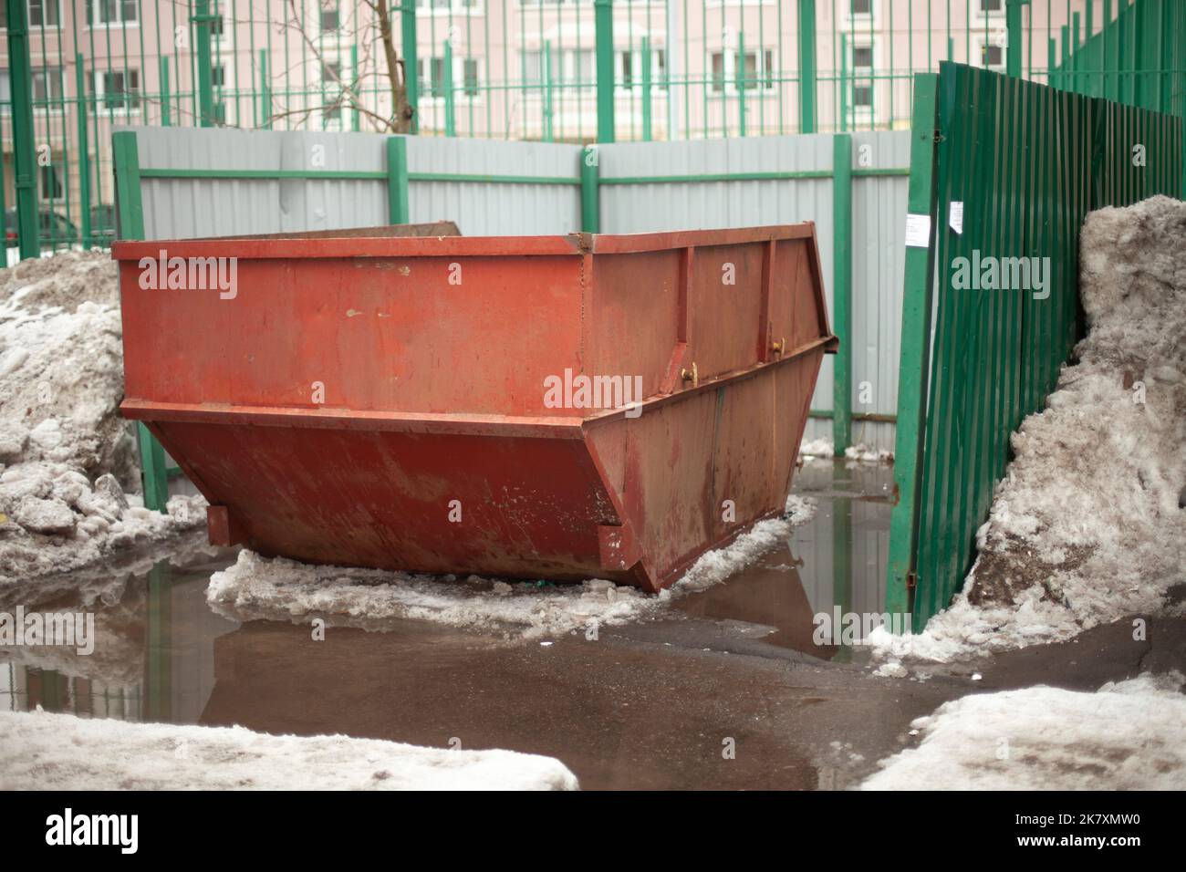 Garbage container. Steel waste tank in city. Large garbage can in yard
