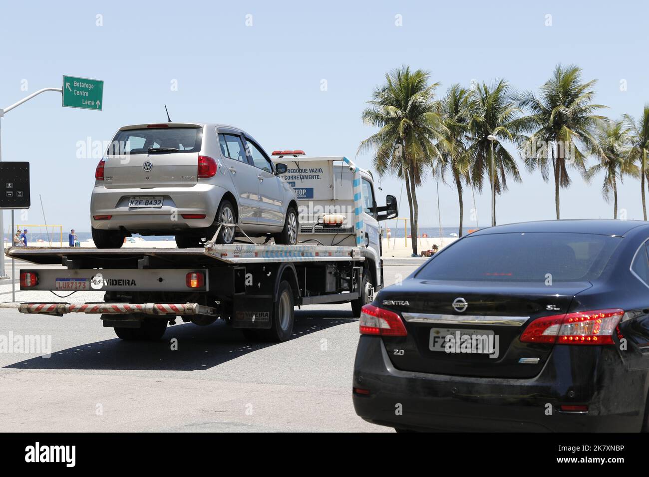 Tow truck towing impounded vehicles for traffic violations. Illegal parking, punishment and fine for irregular driving Stock Photo