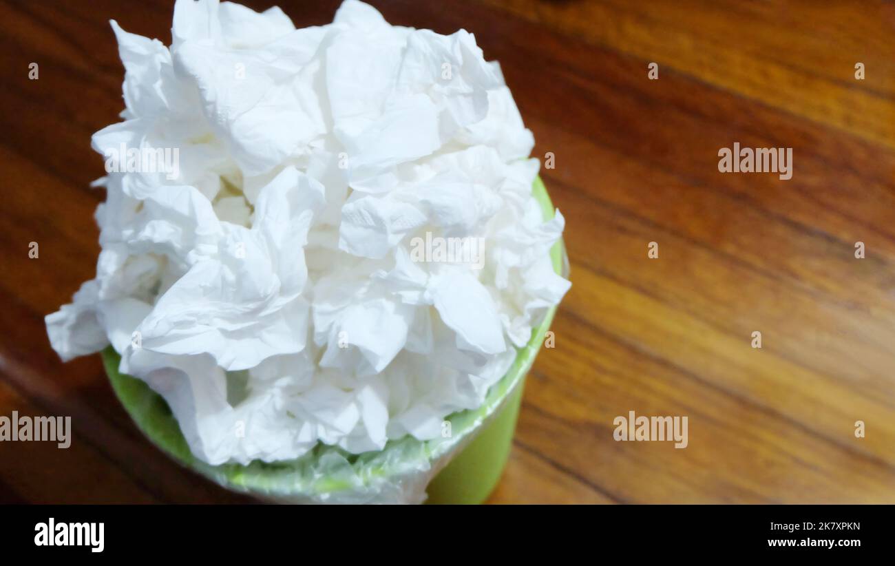 Close up of small garbage bin full with used tissue paper, pilling on top of one another. Stock Photo