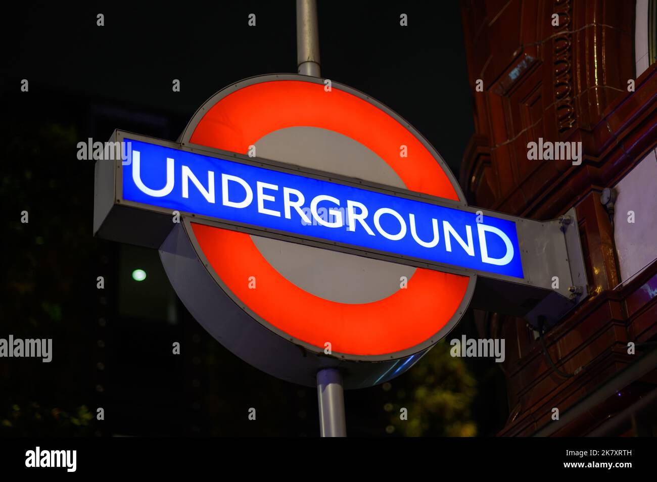 LONDON - November 1, 2020: London Underground Tube Station sign illuminated at night Stock Photo