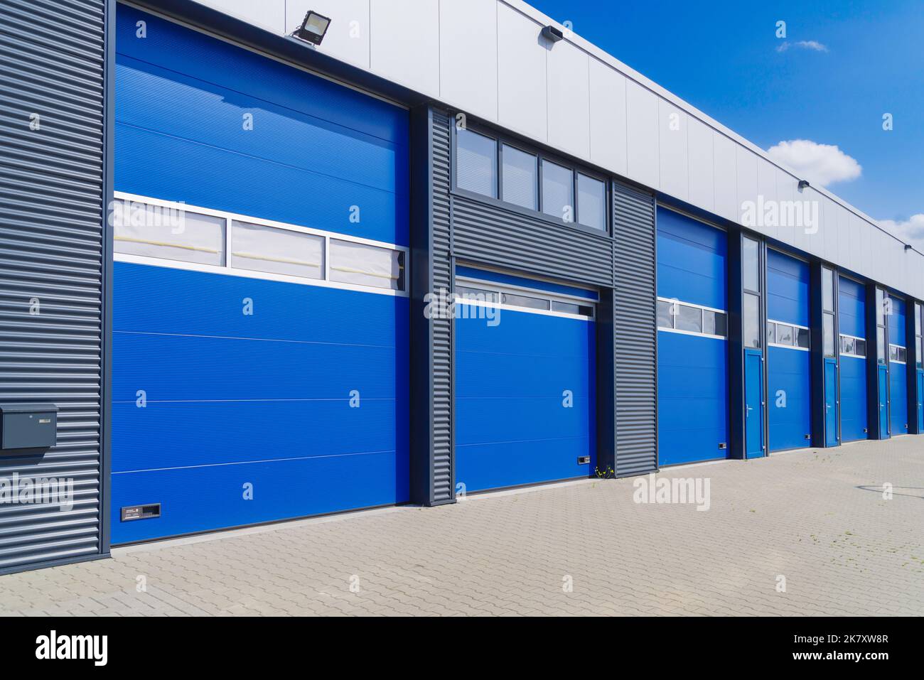 industrial unit with blue shutter doors Stock Photo