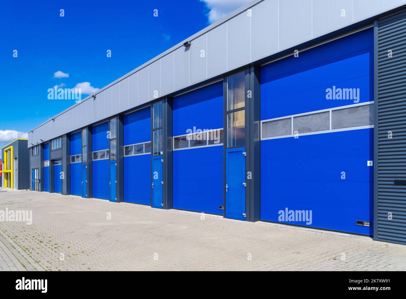 industrial unit with blue shutter doors Stock Photo