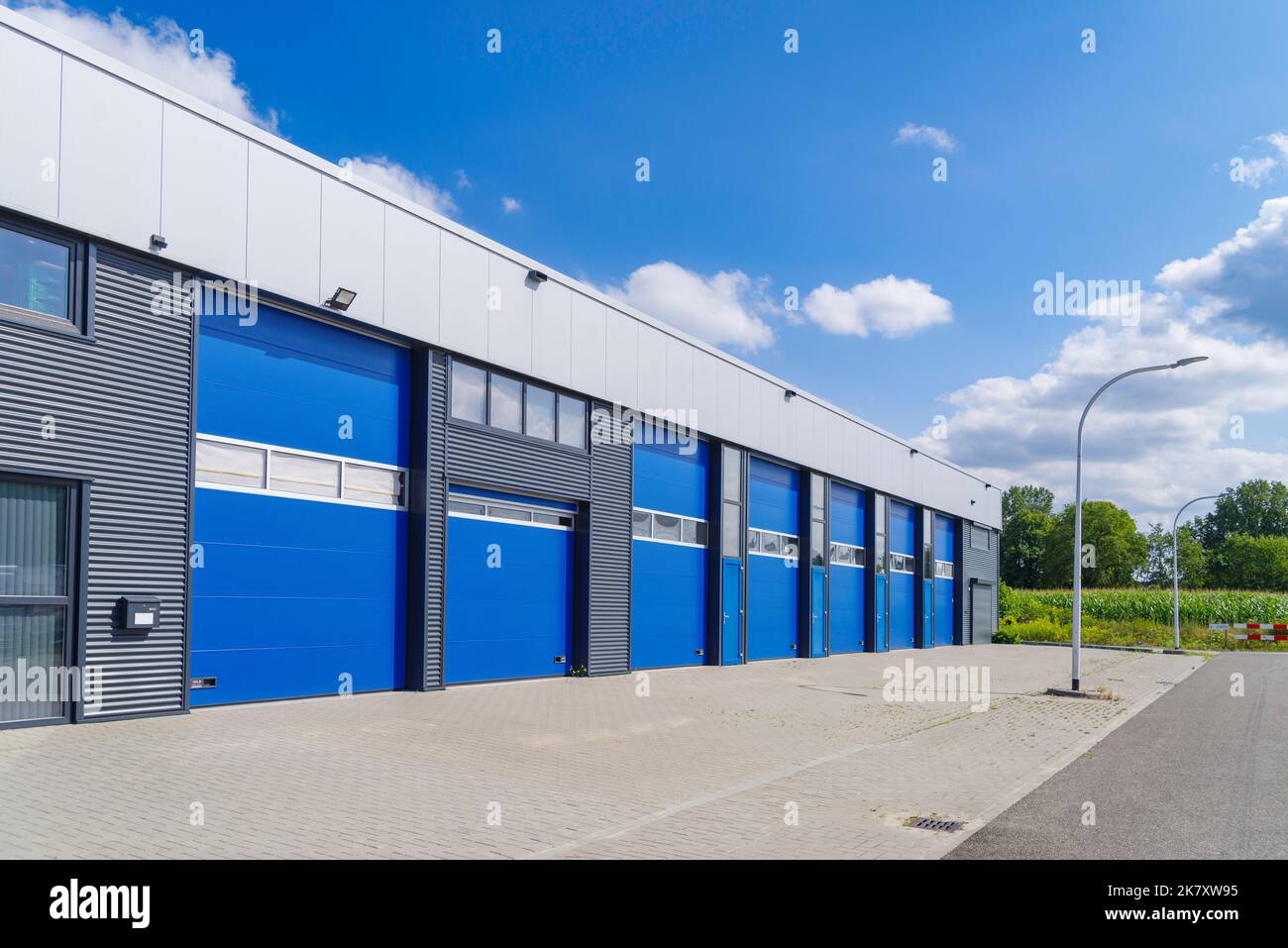 industrial unit with blue shutter doors Stock Photo Alamy