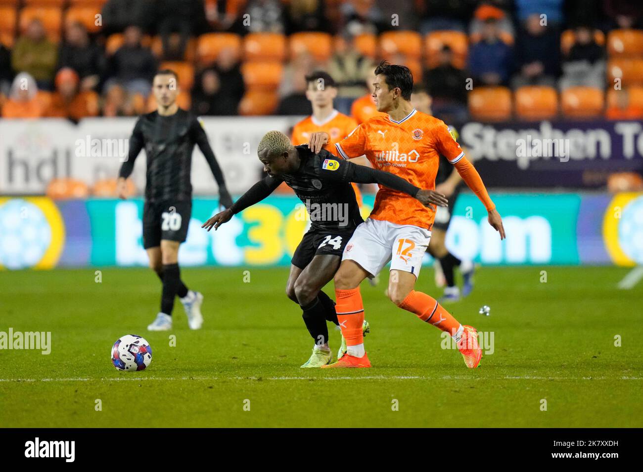 Jean Micha‘l Seri 24 of Hull City competes for the ball with Kenny Dougall 12 of Blackpool