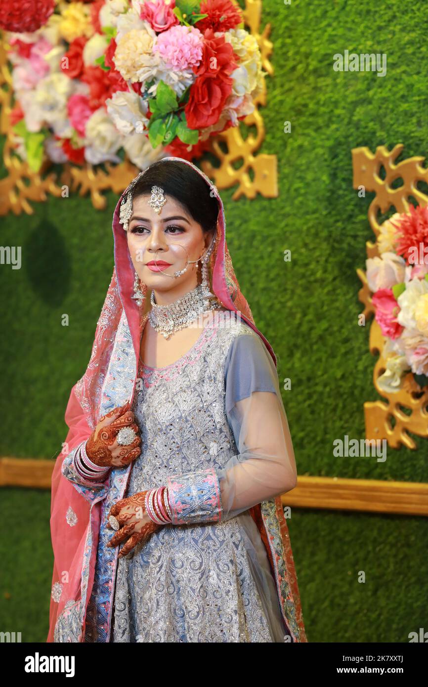Mother in law help for indian pakistani bride to wear golden jewelry  bracelets and rings during henna mehndi sangeet ladies party night Stock  Photo - Alamy