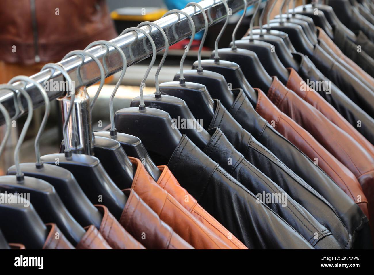 many leather jackets hung on hangers in the worked leather clothing