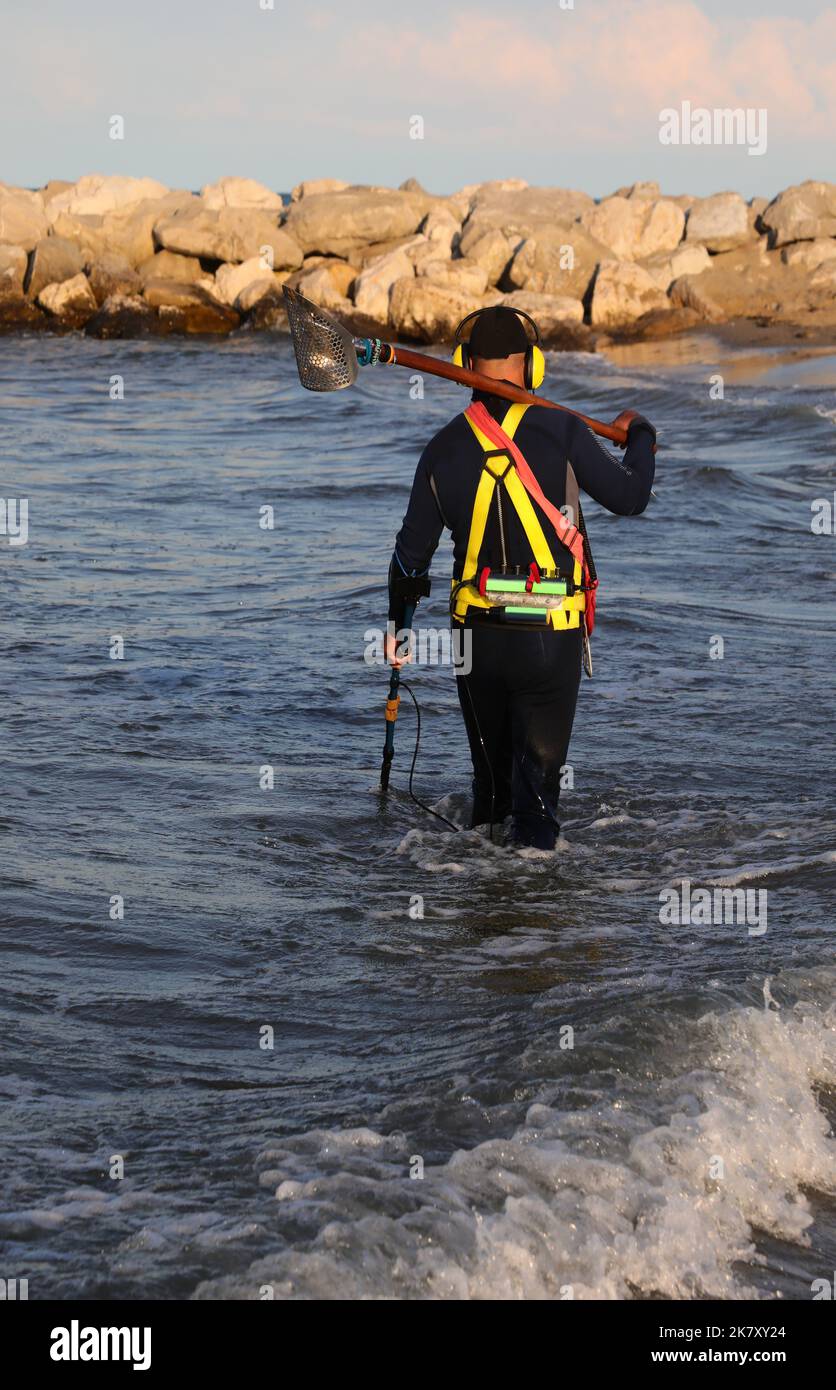 Man recovering while searching with the metal detector for objects lost ...