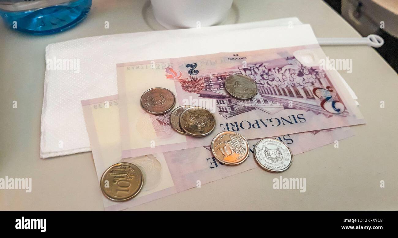 Singapore dollar money coins and bills on plane in Singapore in