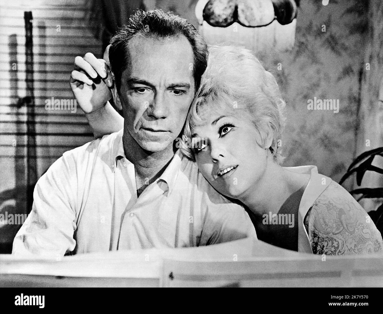 Ray Walston & Kim Novak Film: Kiss Me, Stupid (1964) Characters: Orville Jeremiah Spooner & Polly the Pistol  Director: Billy Wilder 22 December 1964   **WARNING** This Photograph is for editorial use only and is the copyright of LOPERT PICTURES and/or the Photographer assigned by the Film or Production Company and can only be reproduced by publications in conjunction with the promotion of the above Film. A Mandatory Credit To LOPERT PICTURES is required. The Photographer should also be credited when known. No commercial use can be granted without written authority from the Film Company. Stock Photo