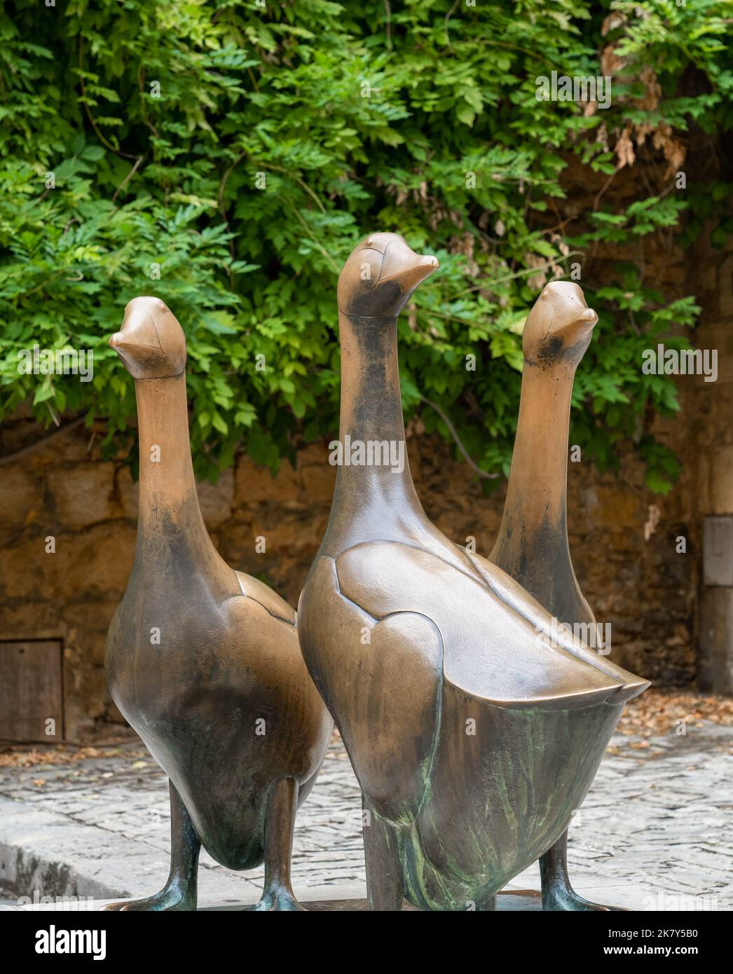 three bronze geese statues, emblems of the duck, geese and foie gras