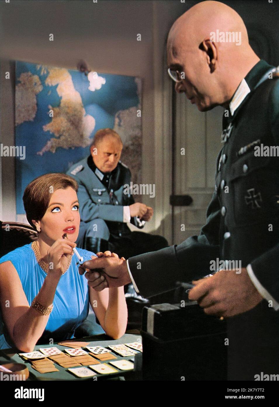 Romy Schneider, Gert Frobe & Yul Brynner Film: Triple Cross (1965) Characters: The Countess, & Baron Von Grunen  Director: Terence Young 09 December 1966   **WARNING** This Photograph is for editorial use only and is the copyright of WARNER BROS and/or the Photographer assigned by the Film or Production Company and can only be reproduced by publications in conjunction with the promotion of the above Film. A Mandatory Credit To WARNER BROS is required. The Photographer should also be credited when known. No commercial use can be granted without written authority from the Film Company. Stock Photo