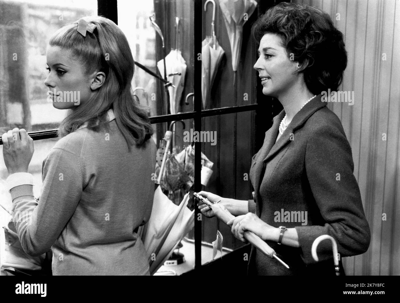 Catherine Deneuve & Anne Vernon Film: The Umbrellas Of Cherbourg; Les Parapluies De Cherbourg (Les parapluies de Cherbourg) Characters: Genevieve Emery & Madame Emery  Fr 1964, Director: Jacques Demy 19 February 1964   **WARNING** This Photograph is for editorial use only and is the copyright of PARC FILM and/or the Photographer assigned by the Film or Production Company and can only be reproduced by publications in conjunction with the promotion of the above Film. A Mandatory Credit To PARC FILM is required. The Photographer should also be credited when known. No commercial use can be granted Stock Photo