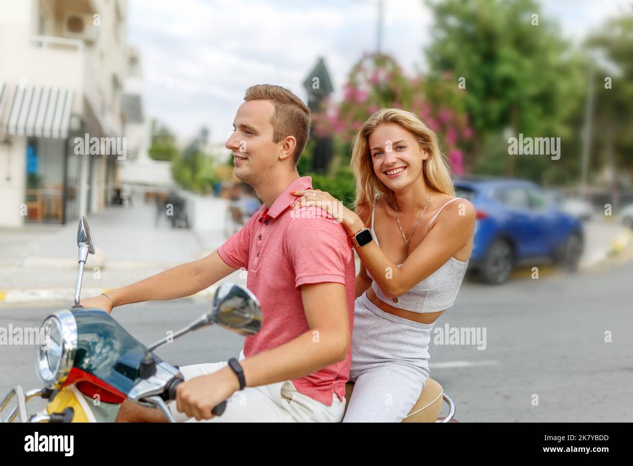 Happy couple in love riding a motorbike on summer city streets ,man and ...