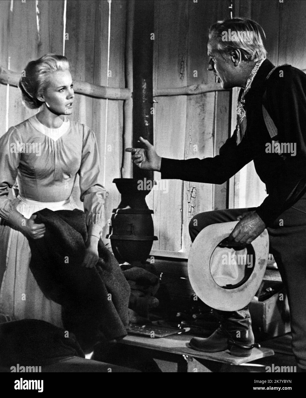 Carroll Baker & Richard Widmark Film: Cheyenne Autumn (1964) Characters: Deborah Wright, Capt. Thomas Archer  Director: John Ford 03 October 1964   **WARNING** This Photograph is for editorial use only and is the copyright of WARNER BROS and/or the Photographer assigned by the Film or Production Company and can only be reproduced by publications in conjunction with the promotion of the above Film. A Mandatory Credit To WARNER BROS is required. The Photographer should also be credited when known. No commercial use can be granted without written authority from the Film Company. Stock Photo