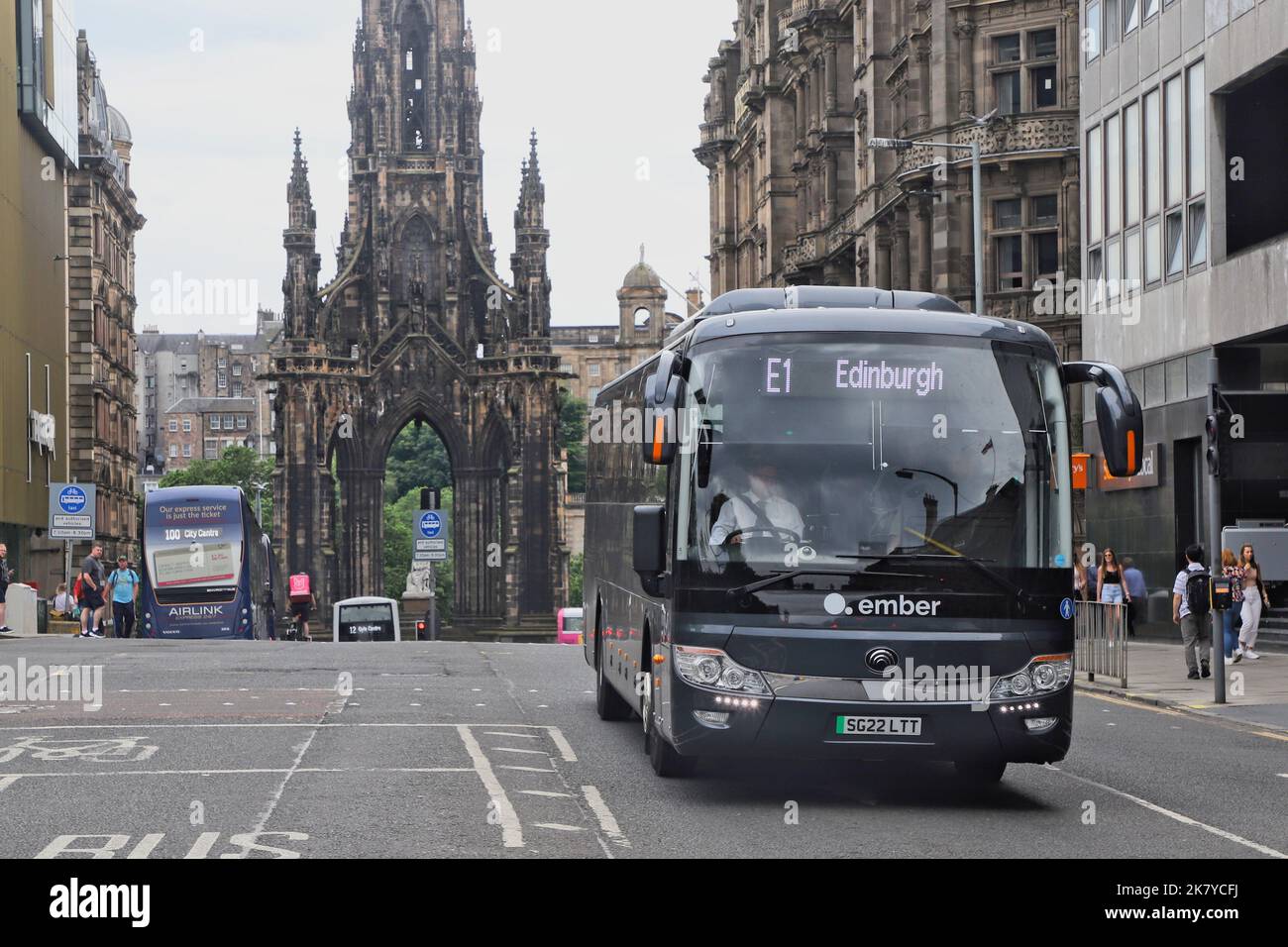 Ember electric intercity coach with Scott Monument Edinburgh Scotland