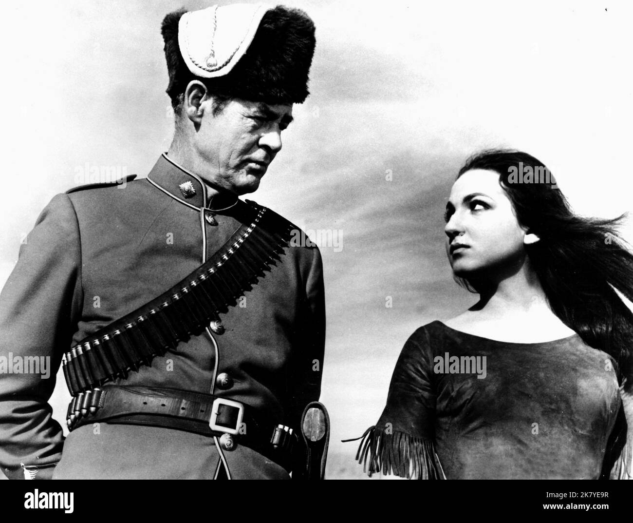 Robert Ryan & Teresa Stratas Film: The Canadians (1961) Characters: Inspector William Gannon & The White Squaw  Director: Burt Kennedy 11 March 1961   **WARNING** This Photograph is for editorial use only and is the copyright of 20 CENTURY FOX and/or the Photographer assigned by the Film or Production Company and can only be reproduced by publications in conjunction with the promotion of the above Film. A Mandatory Credit To 20 CENTURY FOX is required. The Photographer should also be credited when known. No commercial use can be granted without written authority from the Film Company. Stock Photo