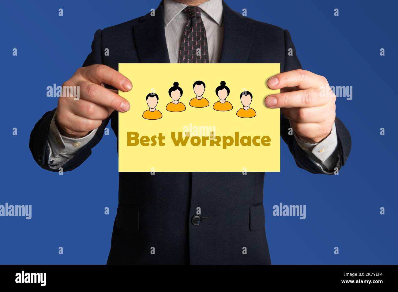 Best workplace. Businessman holding a sheet of paper stating Best Workplace. Employee experience. Attracting talent. Stock Photo